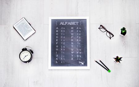 Alphabet Chalkboard at the Center of Assorted Items