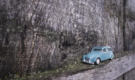 Antique Car Toy Against Wooden Wall