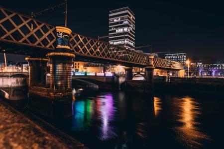 Architectural Photo of Brown Concrete Bridge and High Rise Building during Night Time