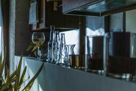 Assorted Clear Glass Bottles With Wine Glass in the Shelf