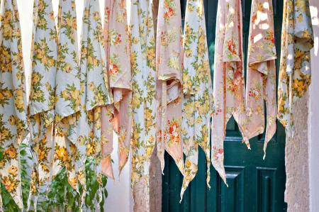 Assorted Textile Lot Hanging Beside Blue Wooden Door