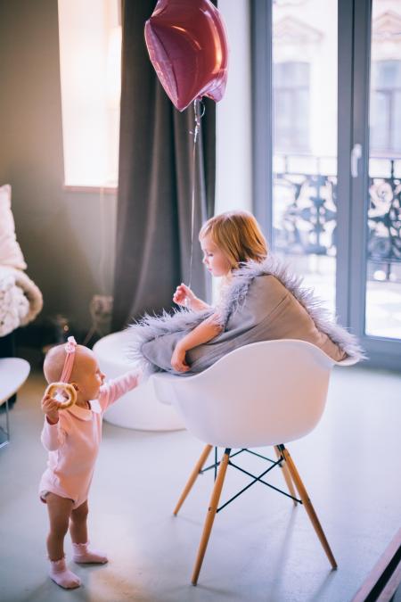 Baby and Girl Playing With Balloon