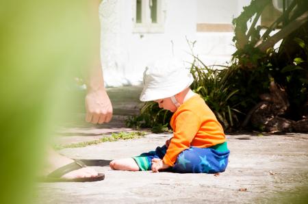 baby boy playing with dad outside