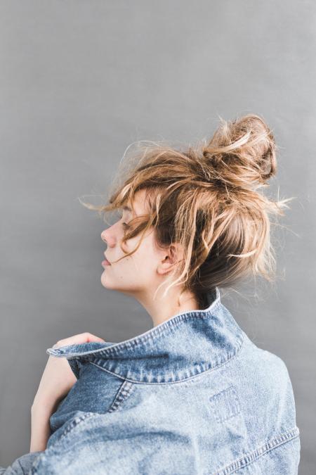 Back View of Woman Holding Her Denim Jacket