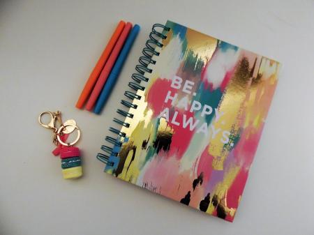 Be Happy Always Spring Notebook Beside Three Assorted-color Pens