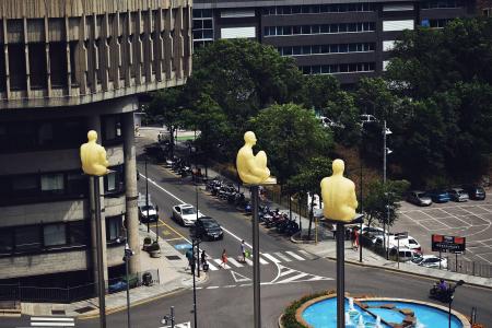 Birds Eye View Photo of Sitting Statues on Outdoor Post