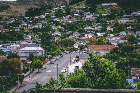 Birds Eye View Photography of Cars on Street Between Houses