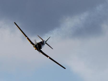 Black Airplane Under Dark Cloud Sky