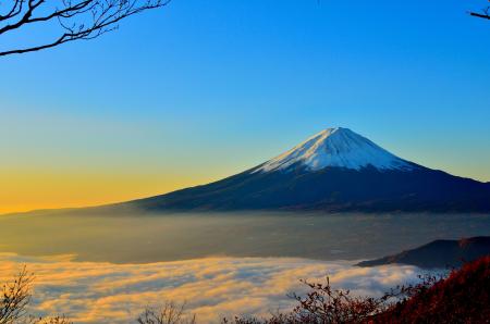 Black and White Mountain over Yellow White and Blue Sky