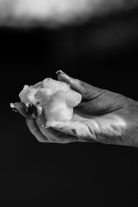 Black-and-white Photo of Hand Holding Snow