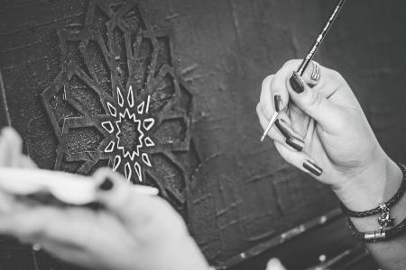 Black and White Photo of Hands Holding a Paintbrush