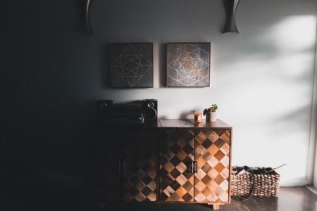 Black Audio Speaker on Brown Wooden Cabinet