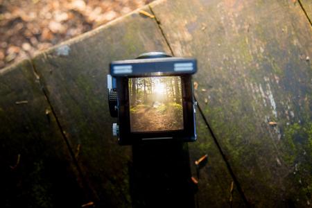 Black Camera on Brown Wooden Table