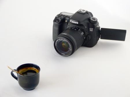 Black Canon Dslr Camera in Front of Coffee in Black Ceramic Teacup