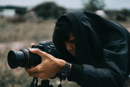 Black Canon Dslr Camera on Hand