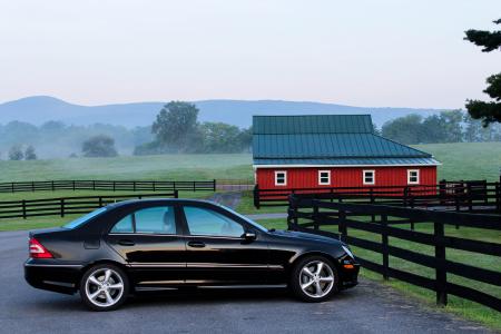 Black Coupe Near Black Wooden Fence during Daytime