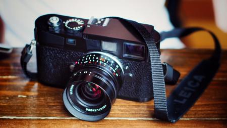 Black Dslr Camera on Top of Brown Wooden Table