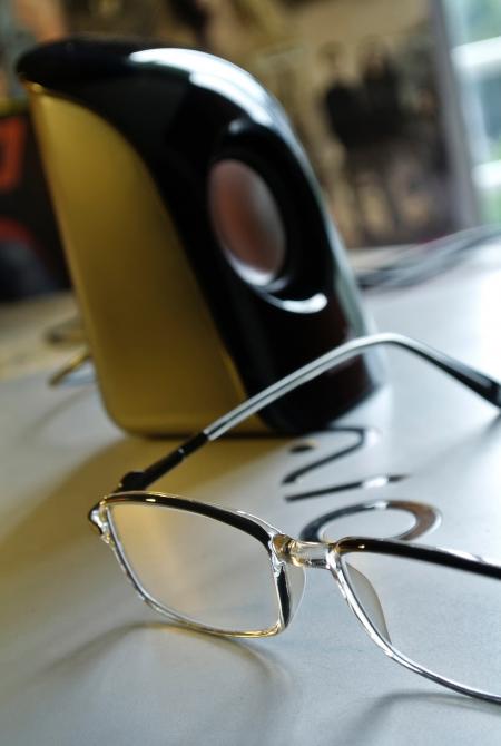 Black Frame Eyeglass Beside Black and White Electric Kettle