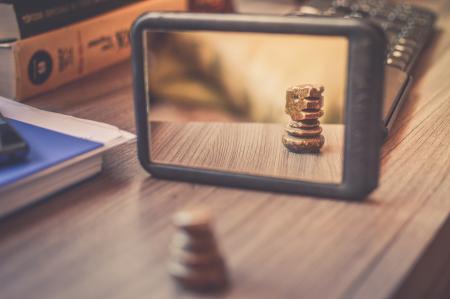 Black Frame Mirror on the Brown Wooden Table