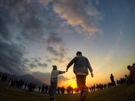 Black Haired Man Wearing Blue Denim Jacket and Orange Pants during Sunset