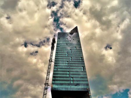 Black High-rise Building With White Clouds