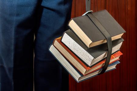 Black Leather Book Strapped Around Four Books