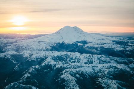 Black Mountain Covered in Snow during Sunset