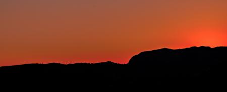 Black Mountain Under Brown Sky during Sunset