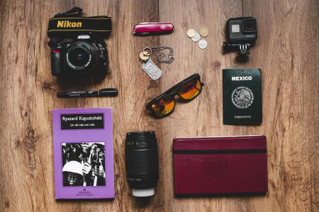 Black Nikon Dslr Camera, Gopro Hero Session, and Black Framed Sunglasses