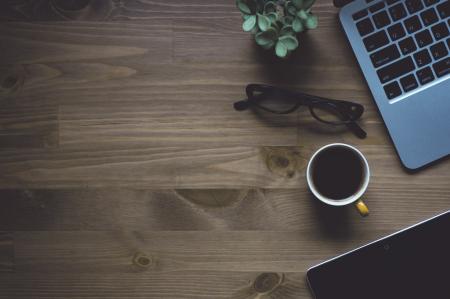 Black Notebook and Mug on Wooden Table