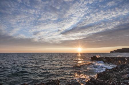 Black Rock Beside the Sea Under the Sunset