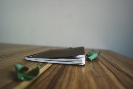 Black Small Notebook on Brown Wooden Surface