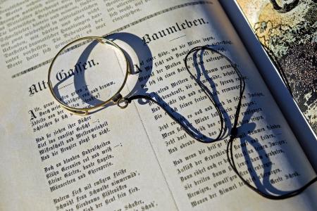 Black String on Top of an Open Book during Daytime