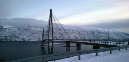 Black Suspension Bridge Under Cumulus Clouds