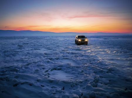 Black Suv on Snow during Golden Hour