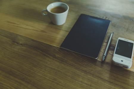 Black Table Computer Beside White Mug