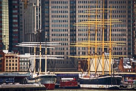 Black White and Yellow Boat Beside Gray Red and White Boat