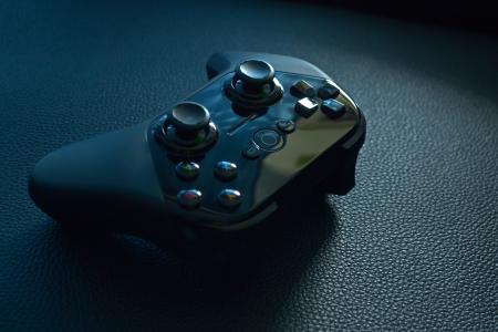 Black Wireless Game Controller on Black Leather