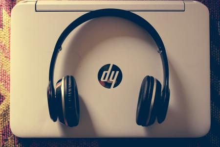Black Wireless Headphone Near White Hp Laptop