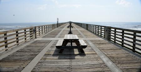 Black Wooden Picnic Table on the Wooden Dock