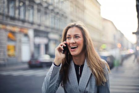 Blonde Hair Woman Wearing Gray Suit Jacket Holding Smartphone