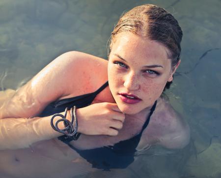 Blonde Haired Woman Wearing Black Bikini in Body of Water