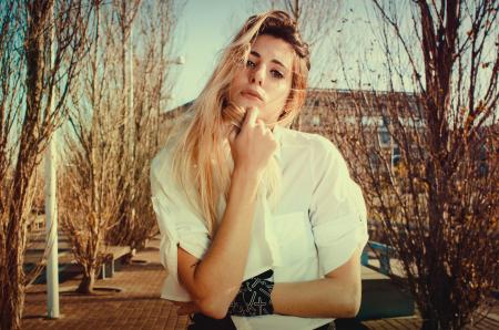 Blonde Woman in White Dress Shirt Beside Brown Plants