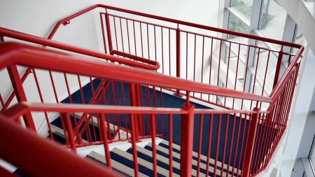 Blue and White Wooden Stairs With Red Metal Handrails