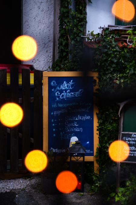 Blue Chalkboard With Brown Wooden Frame Beside Green Plants