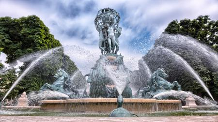 Blue Concrete Water Fountain Near Green Trees Under White Clouds