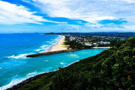 Blue Ocean Near Trees and Mountains Photo