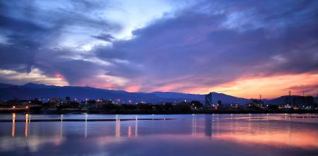 Blue Orange and White Sky over Water and Landscape