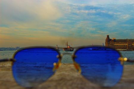 Blue Sunglasses With Black-frame on Concrete Stone