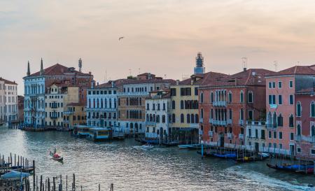 Boat Sailing on Canal Near Buildings during Day Time